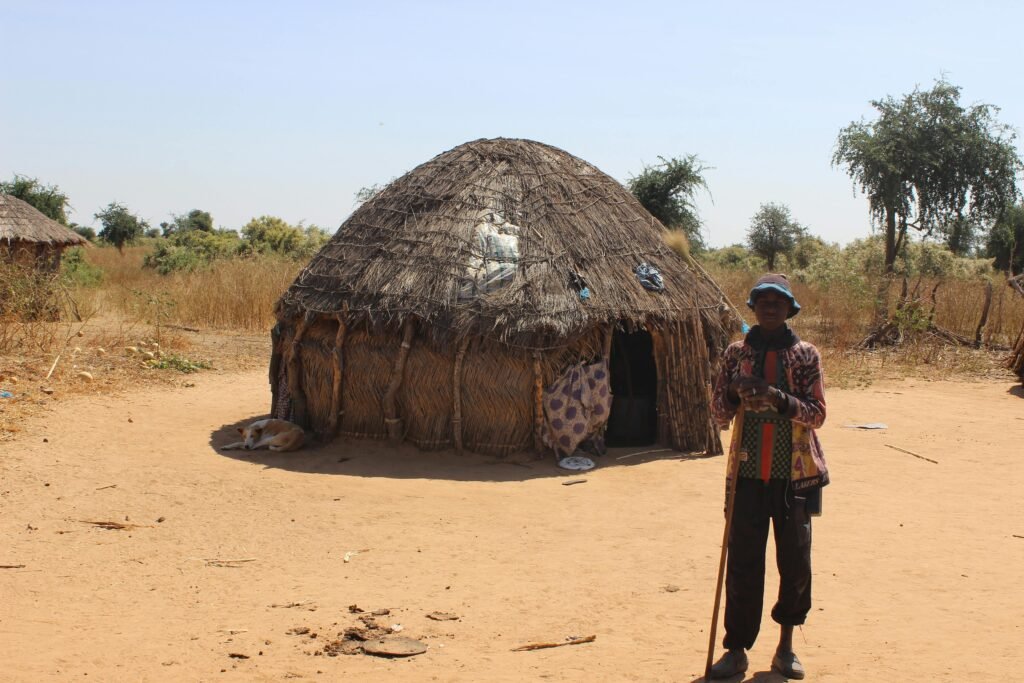 people behind african hut